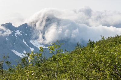 Scenic view of mountains against cloudy sky