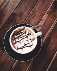 Directly above shot of cappuccino served on table