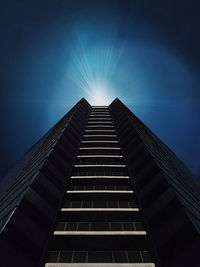 Low angle view of skyscrapers against blue sky