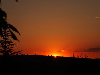 Scenic view of silhouette landscape against romantic sky at sunset