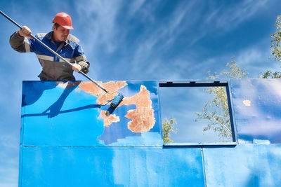 Low angle view of man skateboarding on wall