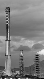 Low angle view of communications tower against sky