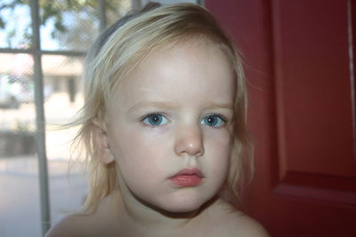 Close-up portrait of cute girl at home