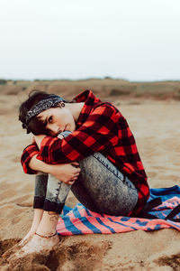 Cute girl sitting on sand