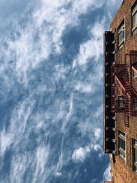 Low angle view of building against cloudy sky