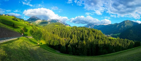 Scenic view of green mountains against sky