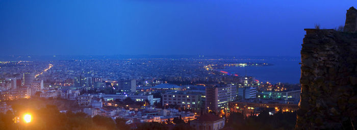 High angle view of illuminated city buildings at dusk