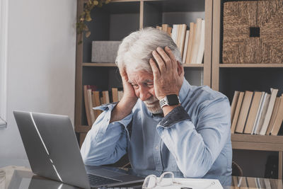 Frustrated businessman sitting in office