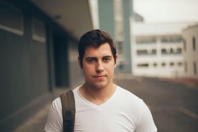 Portrait of young man in city