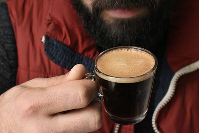 Close-up of man holding coffee cup