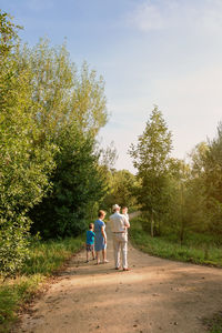 Grandparents walking with grandchildren at park