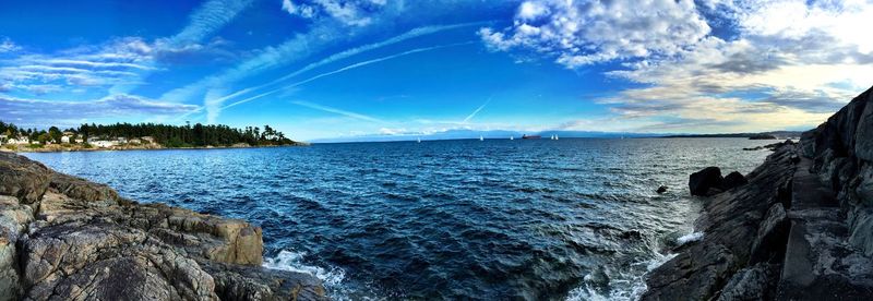 Panoramic view of sea against blue sky