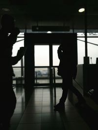 Silhouette people standing in corridor