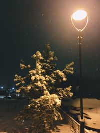 Low angle view of illuminated street light against sky at night