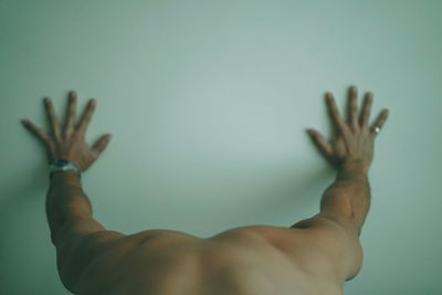 Close-up of man hand against wall