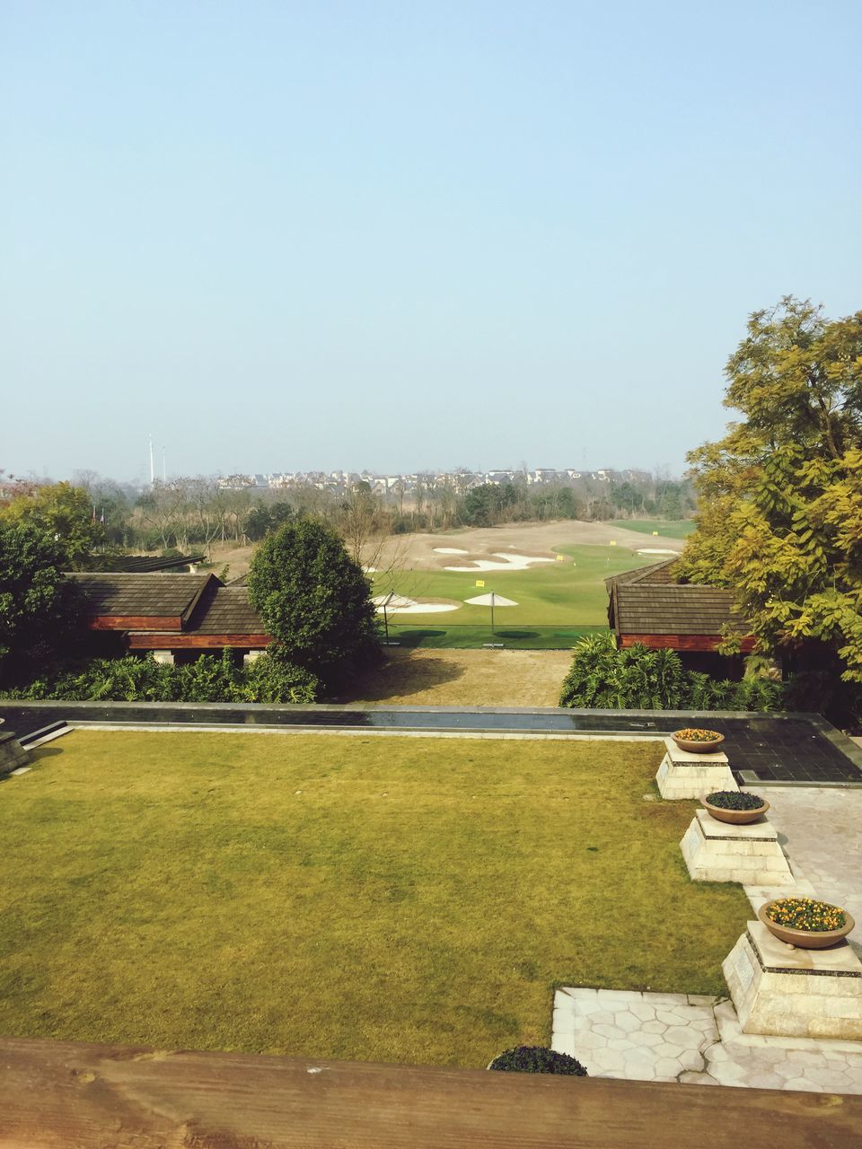 clear sky, copy space, tree, grass, built structure, architecture, building exterior, landscape, field, green color, tranquility, tranquil scene, house, blue, nature, growth, scenics, day, beauty in nature, grassy