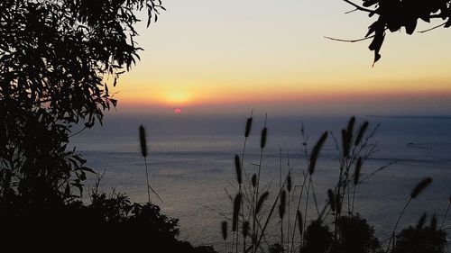 Scenic view of sea against romantic sky at sunset