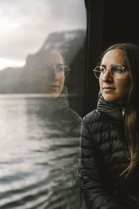 Woman travelling by ferry in fiord