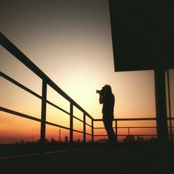Silhouette of woman at sunset