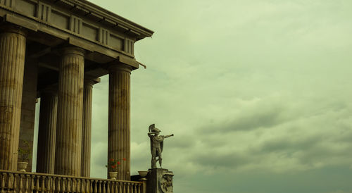 Low angle view of statue against cloudy sky