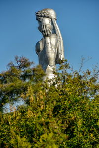 Low angle view of statue against clear blue sky