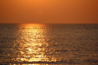 Scenic view of sea against orange sky