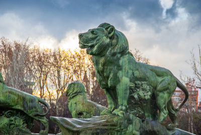 Low angle view of statue against cloudy sky