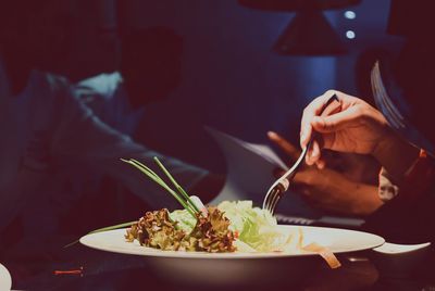 Midsection of woman eating food