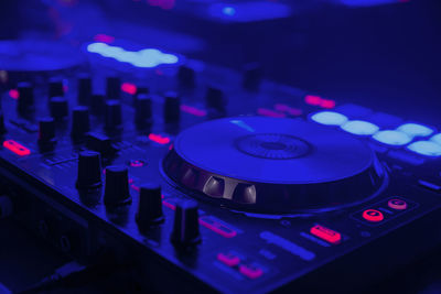 Close-up of sound mixer in illuminated nightclub