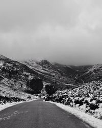 Empty road leading towards mountain