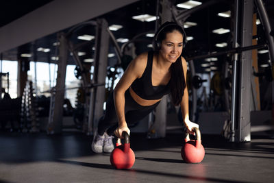 Young woman exercising in gym