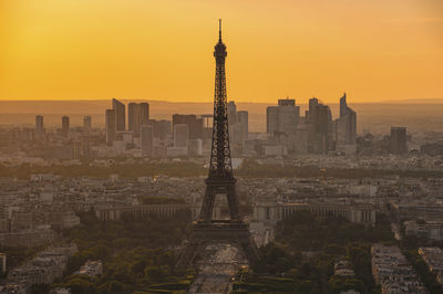 View of eiffel tower in city during sunset