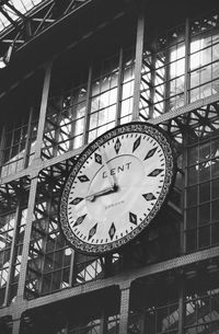 Low angle view of clock on window