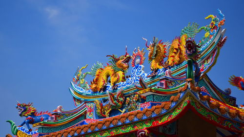 Low angle view of temple against blue sky