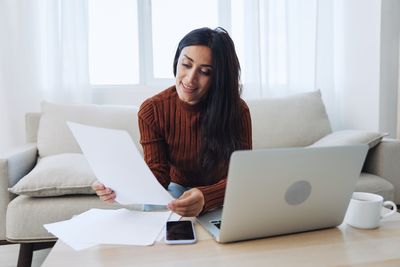 Young woman using laptop at home