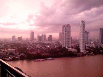 City by river against sky