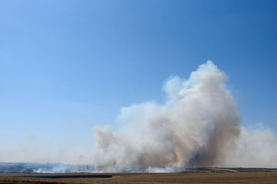 Smoke emitting from geyser against sky