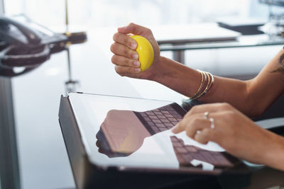 Midsection of woman working on table