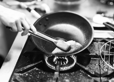 Cropped hand of man preparing food