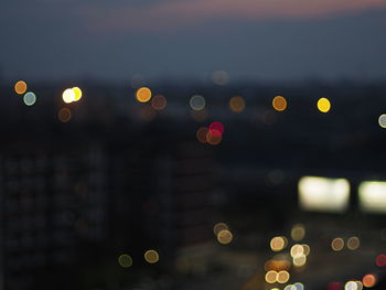 Defocused image of illuminated city at night