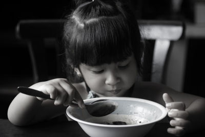 Cute girl eating food at home