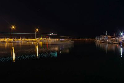 Reflection of illuminated lights in puddle