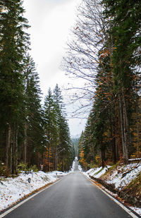 Road passing through snow covered landscape