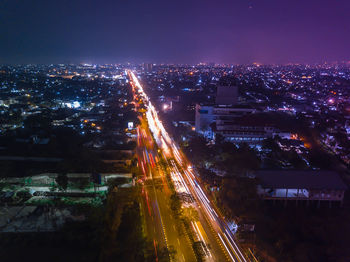 Aerial view of illuminated city street at night