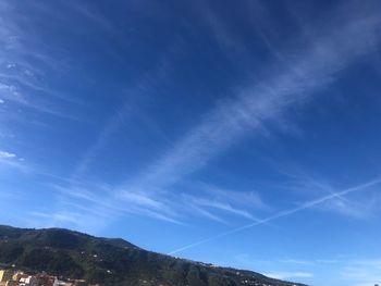 Low angle view of vapor trail in blue sky