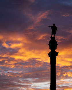 Low angle view of silhouette statue against sky during sunset