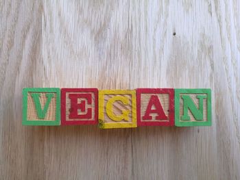 Text with toy blocks on wooden table