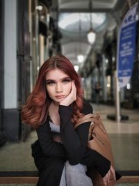 Portrait of a young woman sitting outdoors