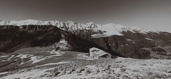 Scenic view of snow covered mountains against sky