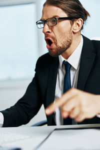 Angry businessman screaming in office